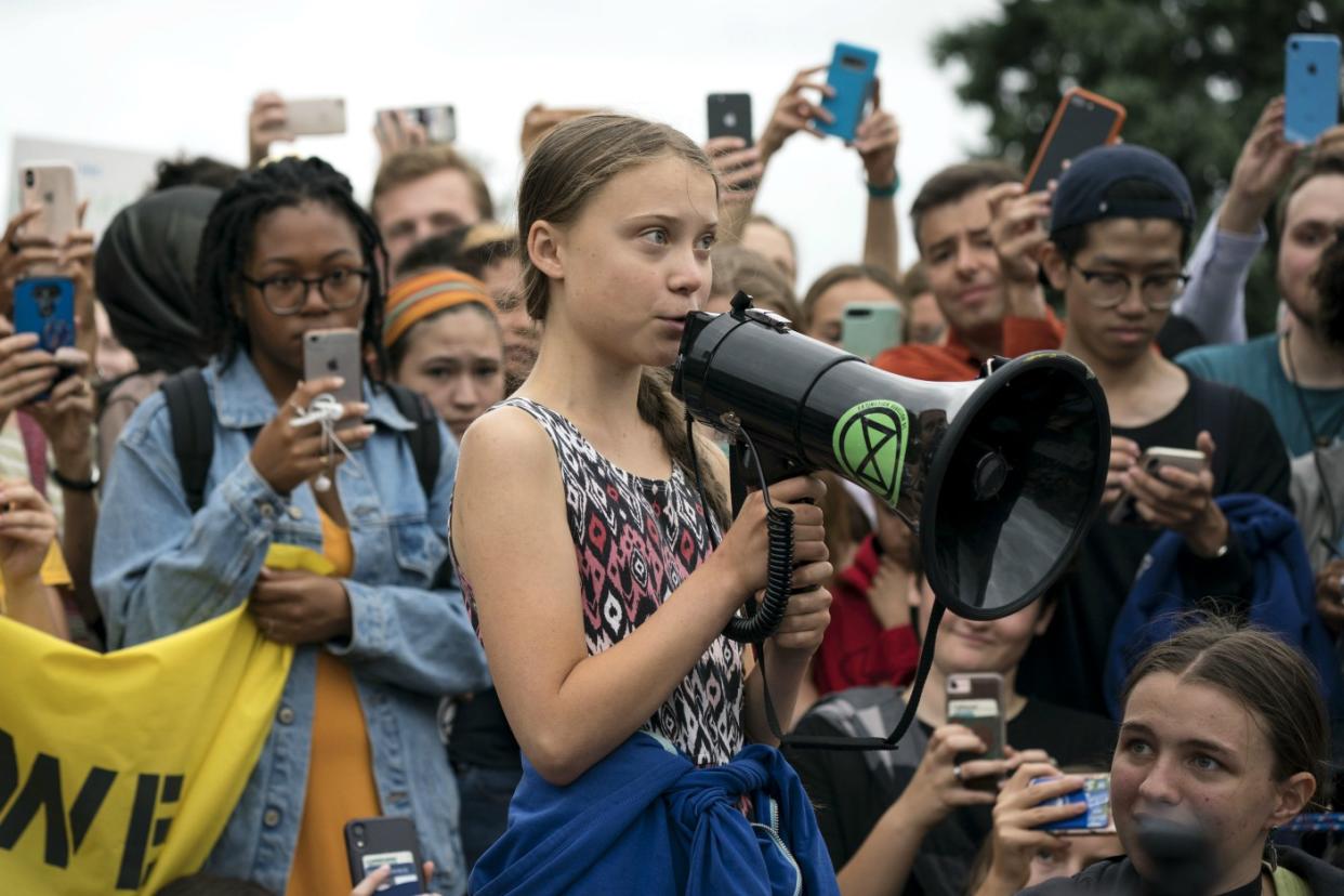 Swedish youth climate activist Greta Thunberg delivers brief remarks surrounded by other student environmental advocates during a strike against climate change outside the White House on September 13, 2019 in Washington, DC. (Photo by Sarah Silbiger/Getty Images)