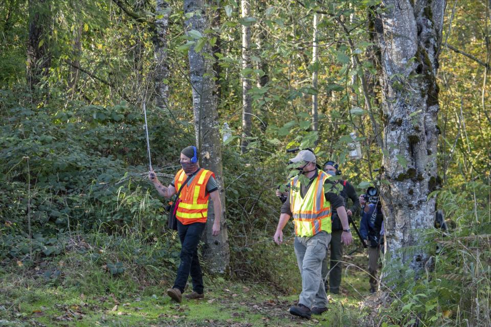 In photo provided by the Washington State Dept. of Agriculture, workers hold an antenna as they follow an Asian Giant Hornet wearing a tracking device, Thursday, Oct. 22, 2020 near Blaine, Wash. Scientists have discovered the first nest of so-called murder hornets in the United States and plan to wipe it out Saturday to protect native honeybees, officials in Washington state said Friday, Oct. 23, 2020. (Karla Salp/Washington Dept. of Agriculture via AP)