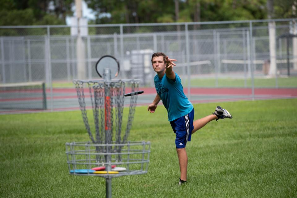 Cole Huden, of Stuart, part of the Treasure Coast Disc Golf Club association's Seabass Strikers team, practices putting on hole 4 at Halpatiokee Regional Park's disc golf course Thursday, Aug. 27, 2020, in Martin County. With Martin County Parks and Recreation expanding the ten-hole course to 18 holes through the woods near an established trail, some local citizens expressed grief over the loss of habitat. "I don't want people to get the wrong idea," Huden said, that disc golfers are trying to "screw anything up." He said the golfers pick up trash as they play and compared to traditional ball golf, destruction from disc golf courses are minimal. 