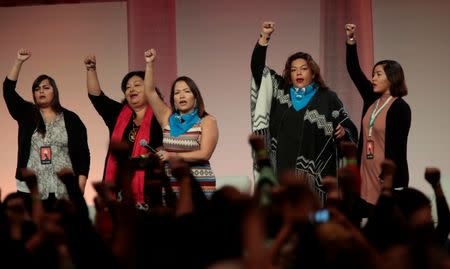 A group of Indigenous women raise their fists as they sing during the opening session of the three-day Women's Convention at Cobo Center in Detroit, Michigan, U.S., October 27, 2017. REUTERS/Rebecca Cook