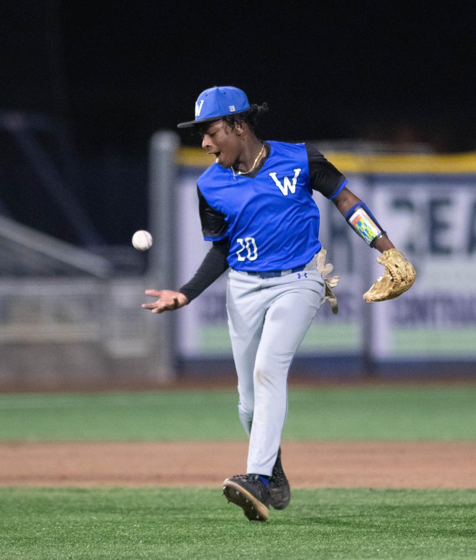 JR Riley (20) snags a sharp shot to shortstop, but can't find the handle to make a throw to first during the Booker T. Washington vs. Escambia baseball game at Blue Wahoos Stadium in Pensacola on Monday, March 25, 2024.