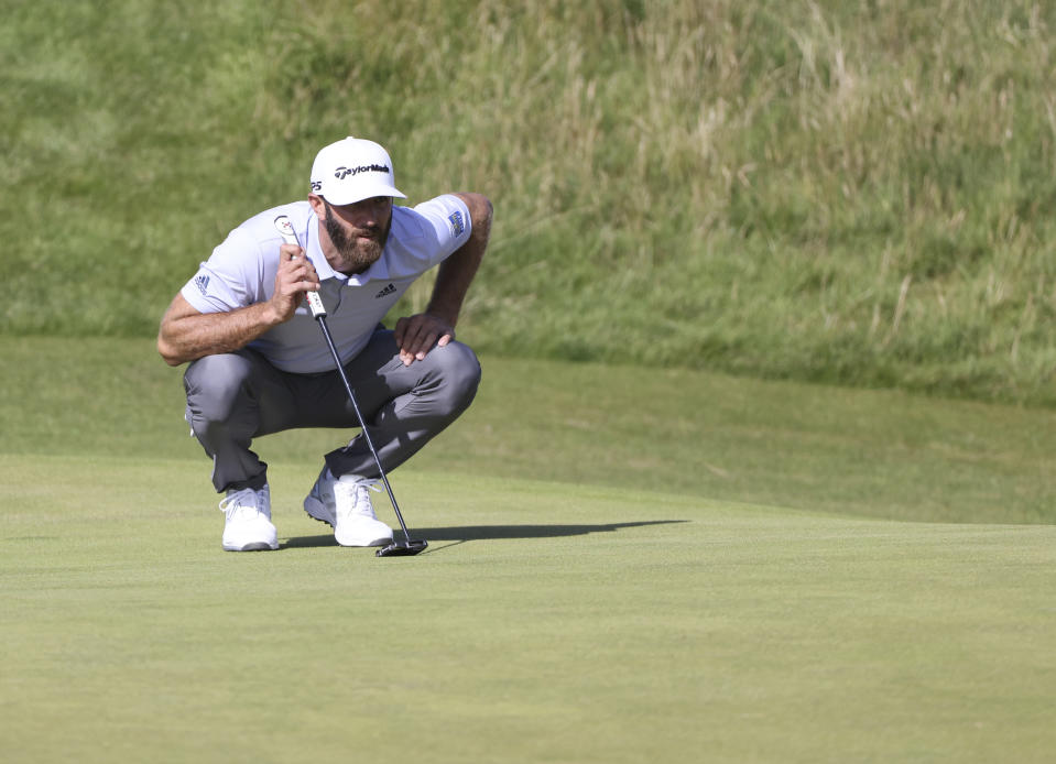 United States' Dustin Johnson lines up his putt on the 6th green during the third round of the British Open Golf Championship at Royal St George's golf course Sandwich, England, Saturday, July 17, 2021. (AP Photo/Ian Walton)
