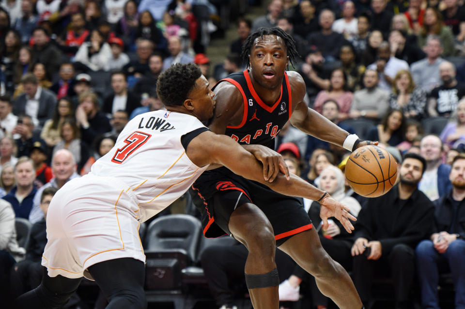 Toronto Raptors forward O.G. Anunoby, right, is defended by Miami Heat guard Kyle Lowry (7) during the first half of an NBA basketball game Tuesday, March 28, 2023, in Toronto. (Christopher Katsarov/The Canadian Press via AP)