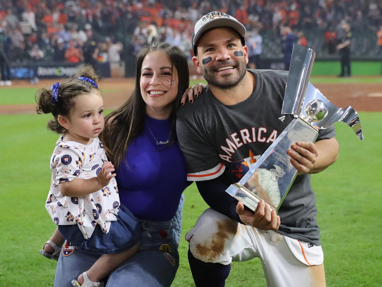 Jose Altuve #27 of the Houston Astros poses with his wife, Nina, and his daughter after they defeated the Boston Red Sox 5-0 in Game Six of the American League Championship Series to advance to the World Series at Minute Maid Park on October 22, 2021 in Houston, Texas