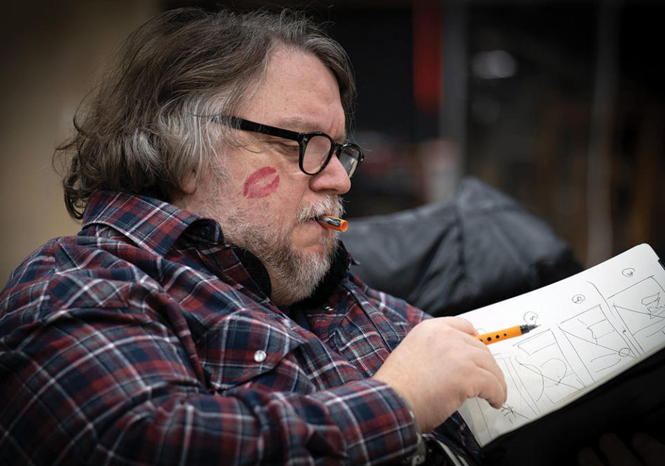 A beloved del Toro reviews sketches on the set of Nightmare Alley. - Credit: Courtesy of Kerry Hayes/Searchlight Pictures