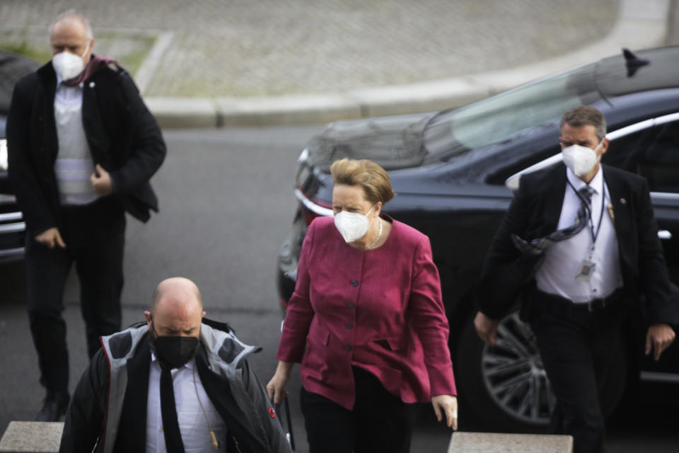 German Chancellor Angela Merkel arrives for a parliament session about a new law to battle the coronavirus pandemic at the parliament Bundestag in Berlin, Germany, Friday, April 16, 2021. (AP Photo/Markus Schreiber)