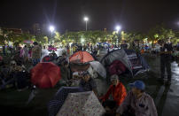 Pro-democracy protesters set up tents at Sanam Luang, a historic field they occupied for a protest rally in Bangkok, Thailand, Saturday, Sept. 19, 2020. Thousands of demonstrators turned out Saturday for a rally to support the student-led protest movement's demands for new elections and reform of the monarchy. (AP Photo/Gemunu Amarasinghe)