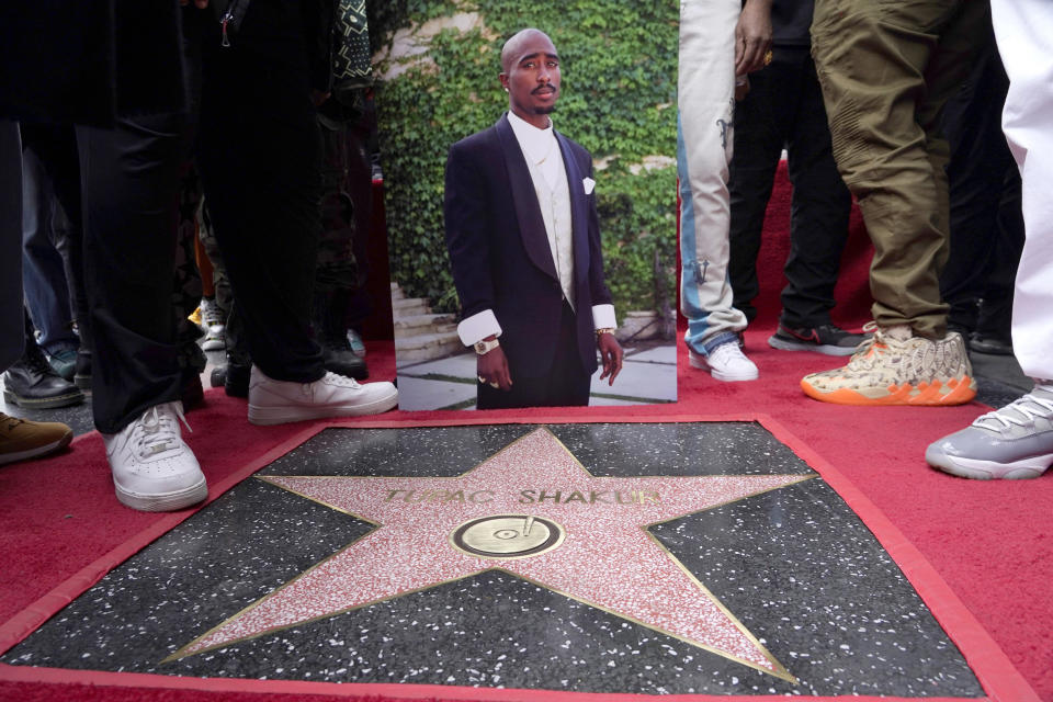 An image of Tupac Shakur appears near his new star on the Hollywood Walk of Fame during a posthumous ceremony in his honor in Los Angeles (Chris Pizzello / AP)