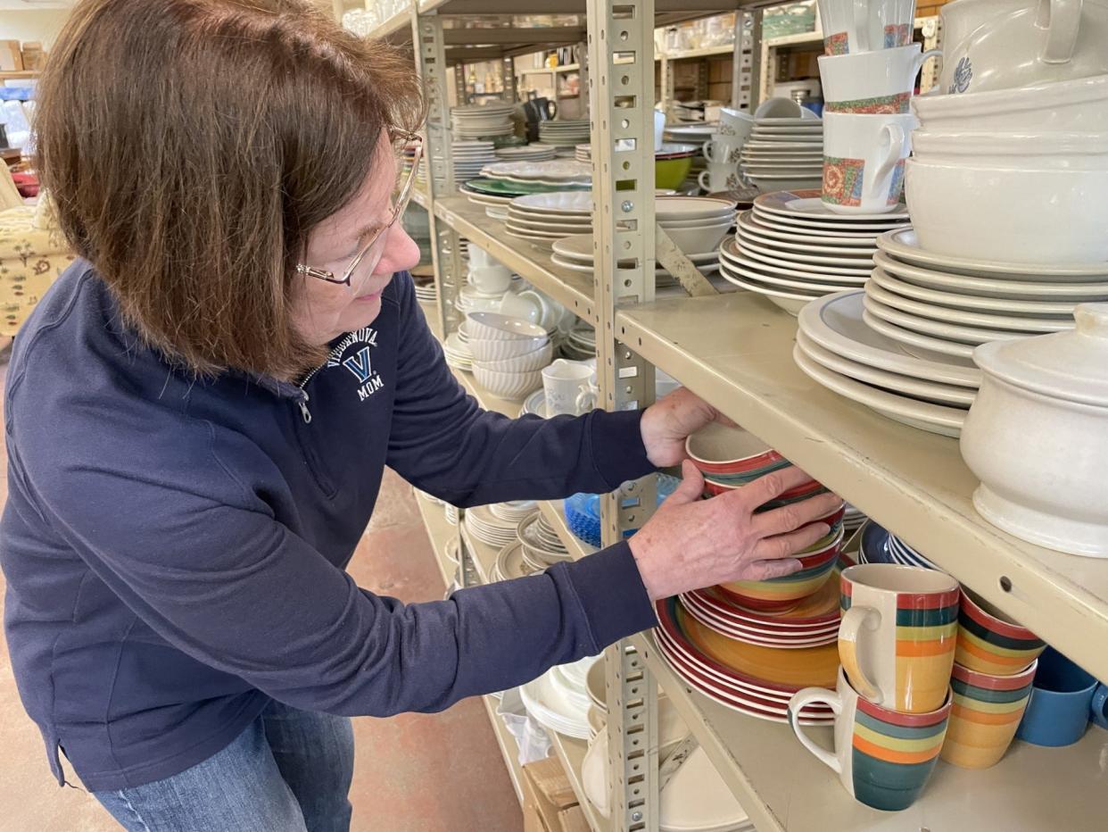 Lorie Bronson, who started the In the Spirit of Giving ministry 16 years ago, looks through kitchen items.