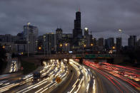 In this photo taken with a long exposure, traffic streaks across the John F. Kennedy Expressway at the start of the Thanksgiving holiday weekend, Wednesday, Nov. 21, 2018, in Chicago. Mild weather and falling gasoline prices are helping Thanksgiving travelers get where they're going while saving a few bucks. (AP Photo/Kiichiro Sato)