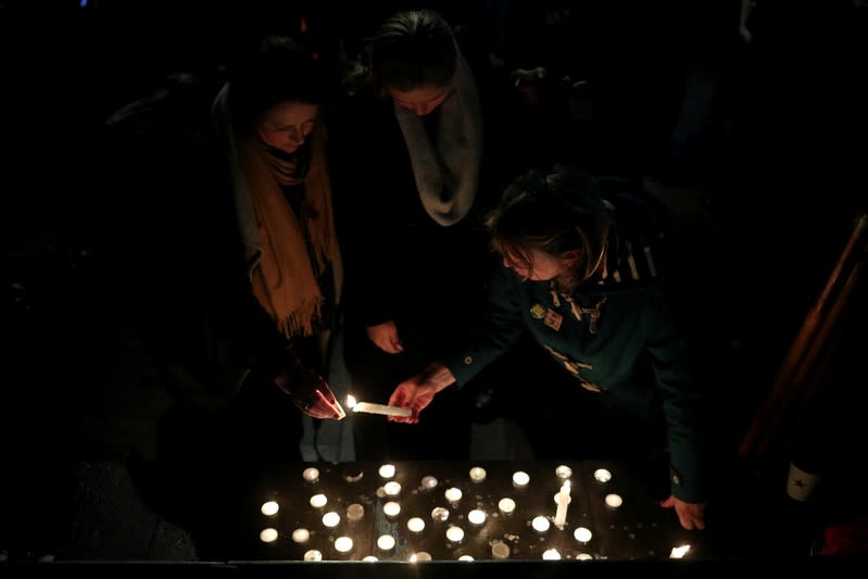 Anti-racism campaigners take part in a vigil, following the discovery of 39 bodies in a truck container, outside the Home Office in London