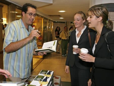 In this photo provided by Subway, Jared Fogle (L), signs a copy of his new book "Jared, The Subway Guy" for Alex Moser (C) and Gigi Garmendia (R) outside a Subway Restaurant in Rockefeller Center, New York City, August 21, 2006. REUTERS/Subway/Ray Stubblebine/HO