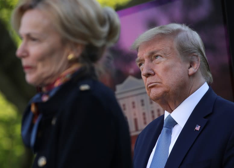 WASHINGTON, DC - APRIL 15: U.S. President Donald Trump listens to Deborah Brix, White House coronavirus response coordinator, speak speak at the daily briefing of the White House Coronavirus Task Force in the Rose Garden at the White House April 15, 2020 in Washington, DC. The Treasury Department has ordered the IRS to put Trump's signature on the stimulus checks that are being sent to all Americans in response to the nation's shutdown due to the COVID-19 pandemic. (Photo by Alex Wong/Getty Images)