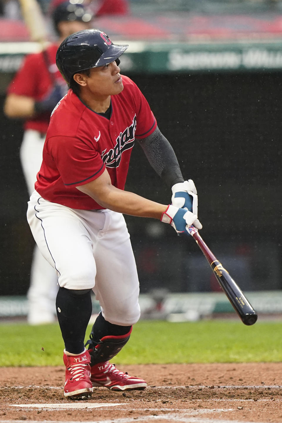 Cleveland Indians' Yu Chang watches his three-run triple in the first inning of a baseball game against the Kansas City Royals, Tuesday, Sept. 21, 2021, in Cleveland. (AP Photo/Tony Dejak)