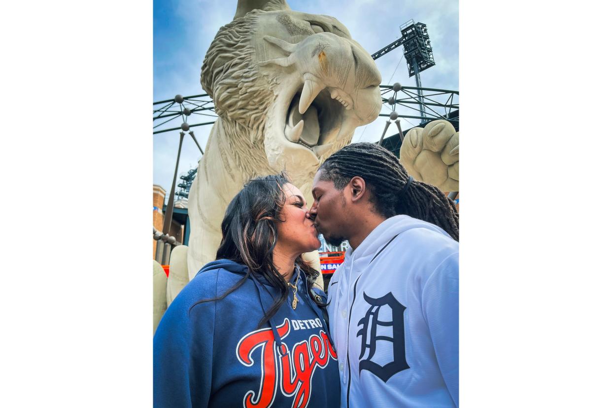 Taleila Cooper, 35, and Ethan Clemons, 36, both of Detroit share a kiss while taking a selfie in front of the Tiger statue in downtown Detroit during the Detroit Tigers' Opening Day at Comerica Park in Detroit on Thursday, April 6, 2023