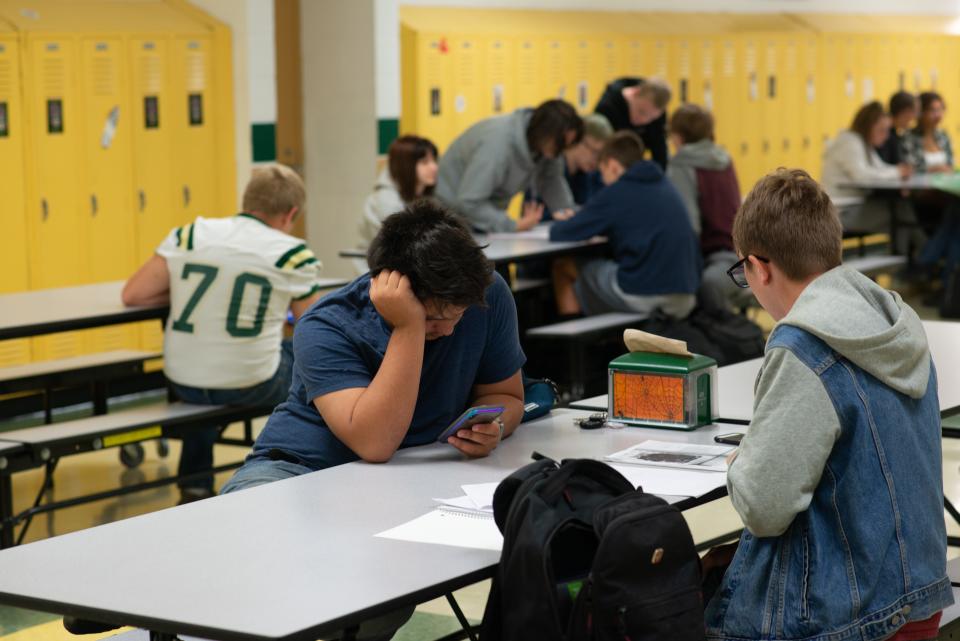 File photo: Unmasked students at Jackson Heights middle and high school eat breakfast inside the cafeteria before class.