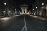 Madeleine square is empty during curfew in Paris, Saturday, Oct. 17, 2020. French restaurants, cinemas and theaters are trying to figure out how to survive a new curfew aimed at stemming the flow of record new coronavirus infections. The monthlong curfew came into effect Friday at midnight, and France is deploying 12,000 extra police to enforce it. (AP Photo/Lewis Joly)