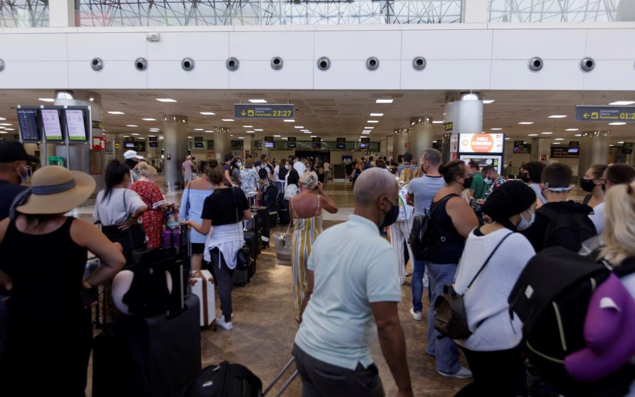 Tourists queues to check in for flights to the UK from Tenerife Sur International Airport on Sunday - RAMON DE LA ROCHA/EPA-EFE/Shutterstock