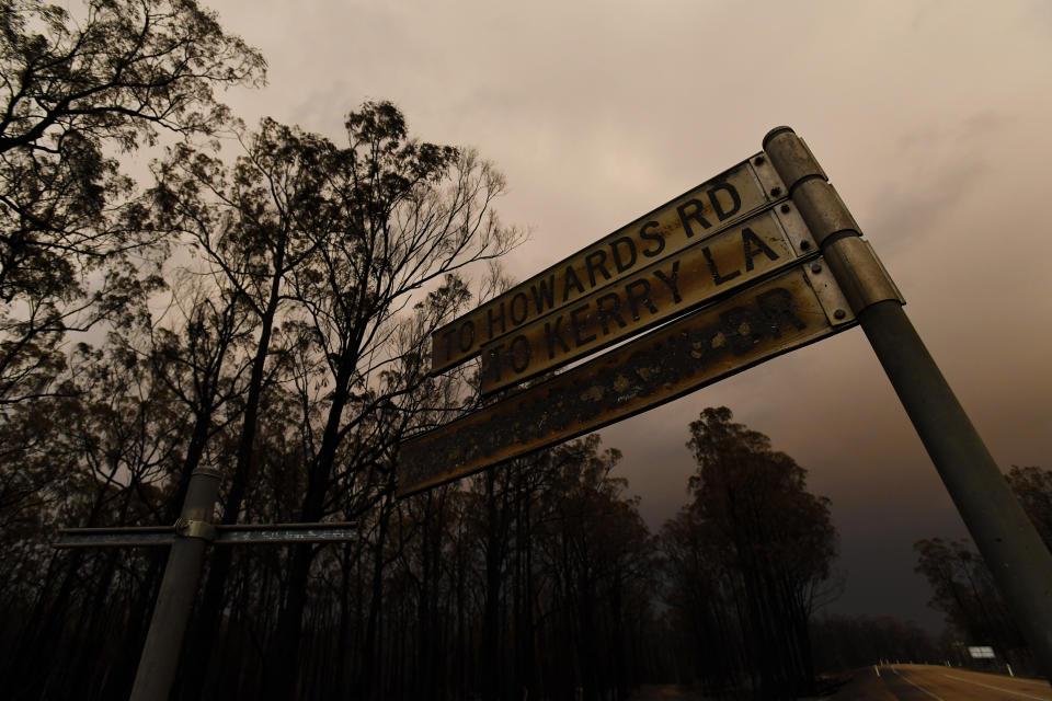 A scorched street sign is seen following a bushfire in Bruthen South, Victoria, Saturday, January 4, 2019. Twenty-two people are dead, 21 more are missing and more than 1500 homes have been destroyed as fires burned through over six-million hectares of land. (AAP Image/James Ross)