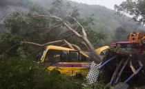 <p>A school bus is struck by a fallen tree during the passage of Super Typhoon Mangkhut near Heng Fa Chuen housing estate in Hong Kong, China, on Sept. 16, 2018.<br>The Hong Kong government hoisted the T10 signal which is the highest and most severe hurricane warning in Hong Kong.<br>(Photo by Alex Hofford, EPA) </p>