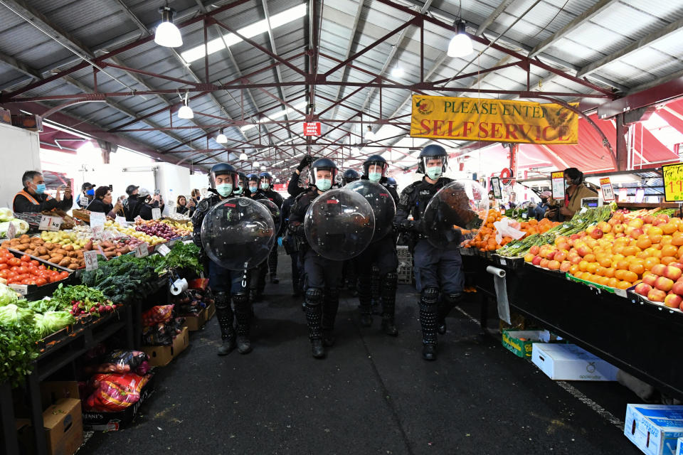 Picture of Victoria Police marching through the Queen Victoria Markets during a Freedom Rally in Melbourne