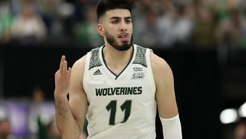 Utah Valley Wolverines center Fardaws Aimaq (11) gestures with a “3” at the BYU bench after scoring three points against BYU at Utah Valley University in Orem on Wednesday, Dec. 1, 2021.