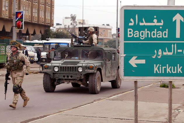 A U.S. soldier from the 4th Infantry Division runs in the street during a patrol in downtown Tikrit, north of Baghdad, on Dec. 16, 2003. The congressional authorization for military action in Iraq, approved in 2002, could soon be ended. (Photo: MAURICIO LIMA/AFP via Getty Images)