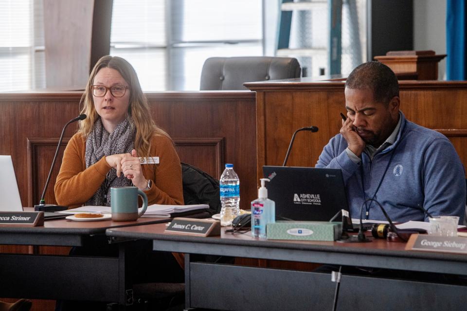 Asheville City School Board members Rebecca Strimer, left, and James Carter, sit in on a meeting January 18, 2024.