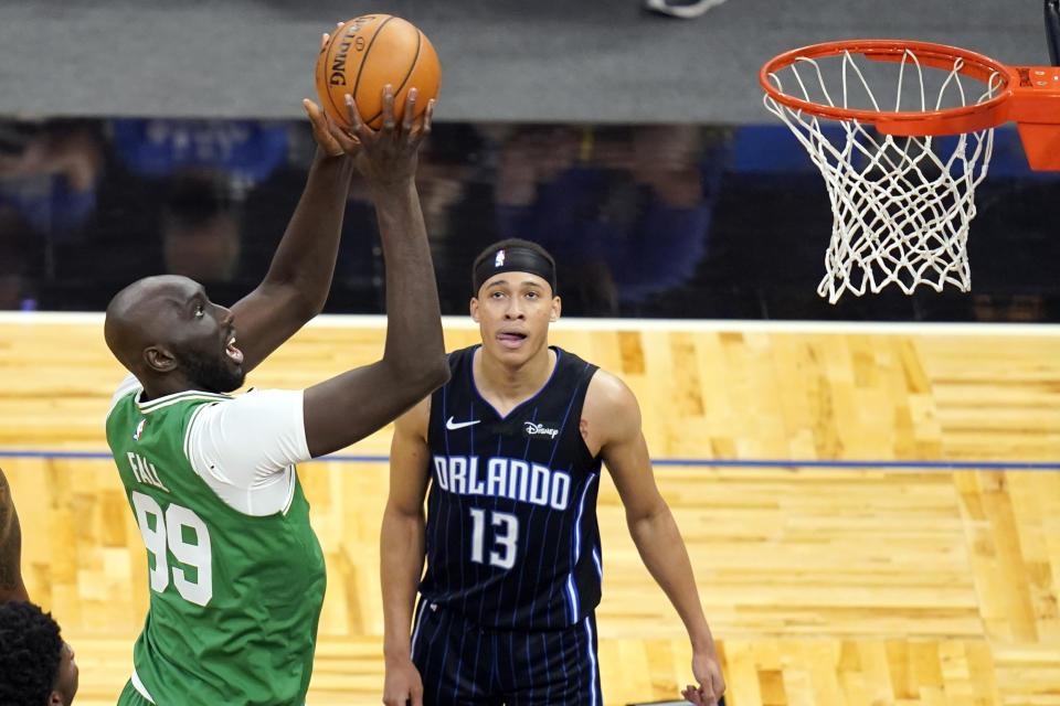 Boston Celtics center Tacko Fall (99) makes a shot in front of Orlando Magic guard R.J. Hampton (13) during the second half of an NBA basketball game, Wednesday, May 5, 2021, in Orlando, Fla. (AP Photo/John Raoux)