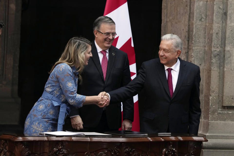 FILE - Mexican Foreign Minister Marcelo Ebrard stands between Mexican President Andres Manuel Lopez Obrador, right, and Canada's Foreign Minister Melanie Joly at a bilateral agreement signing ceremony at the National Palace in Mexico City, Jan. 11, 2023. Ebrard is testing whether his work on the world stage will translate to votes in Mexico as he competes for the ruling party nomination in next year’s presidential elections. (AP Photo/Fernando Llano, File)