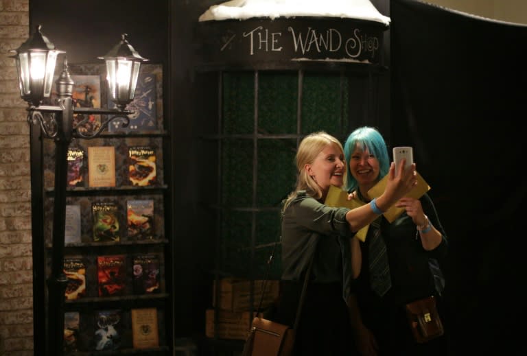 Harry Potter fans take a selfie photograph inside Waterstones bookshop on Piccadilly in central London on July 30, 2016, during the midnight party celebrating the publication of "Harry Potter and the Cursed Child Parts One & Two" script book