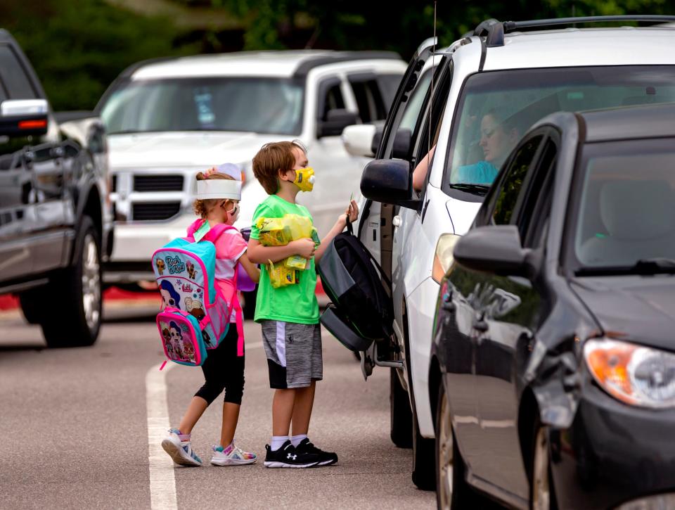 Parents pick up their children Aug. 18, 2021, after the first day of school in the Western Heights school district at Winds West Elementary in Oklahoma City.