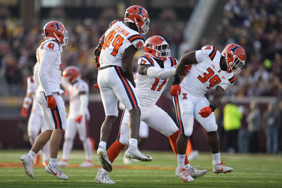 Illinois linebacker Seth Coleman (49) celebrates after sacking Minnesota quarterback Athan Kaliakmanis during the second half of an NCAA college football game Saturday, Nov. 4, 2023, in Minneapolis. (AP Photo/Abbie Parr)