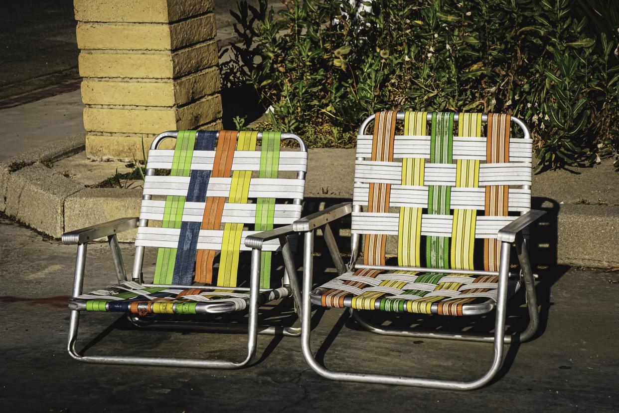 Vintage colorful lawn chairs on concrete during summer