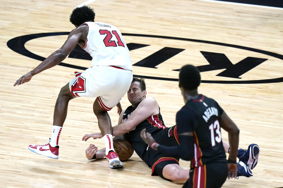Miami Heat guard Goran Dragic, right, falls to the court as Chicago Bulls forward Thaddeus Young (21) defends during the second half of an NBA basketball game, Monday, April 26, 2021, in Miami. (AP Photo/Lynne Sladky)