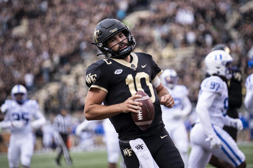 Wake Forest quarterback Sam Hartman (10) scores a touchdown during the first half of an NCAA college football game against Duke on Saturday, Oct. 30, 2021, in Winston-Salem, N.C. (AP Photo/Matt Kelley)