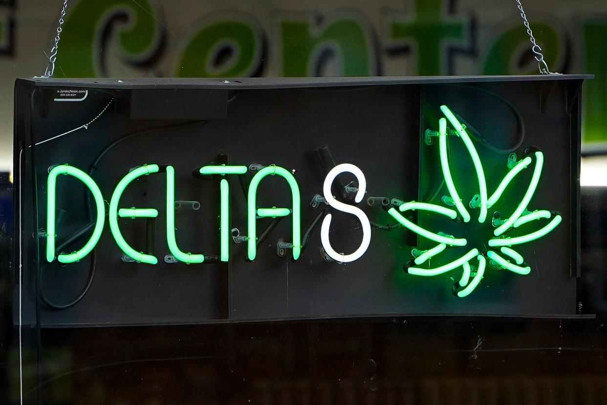 THC products and paraphernalia, including delta 8, are advertised in a window display as being sold at Releaf Center in the University District.