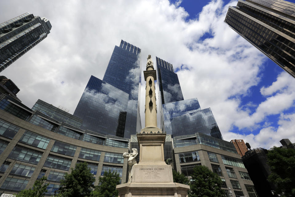 The Columbus Monument by Gaetano Russo and erected at 1892 to commemorate of the 400th anniversary of Columbus' landing in the America  the middle of Columbus Circle with the Time Warner Center in the background.