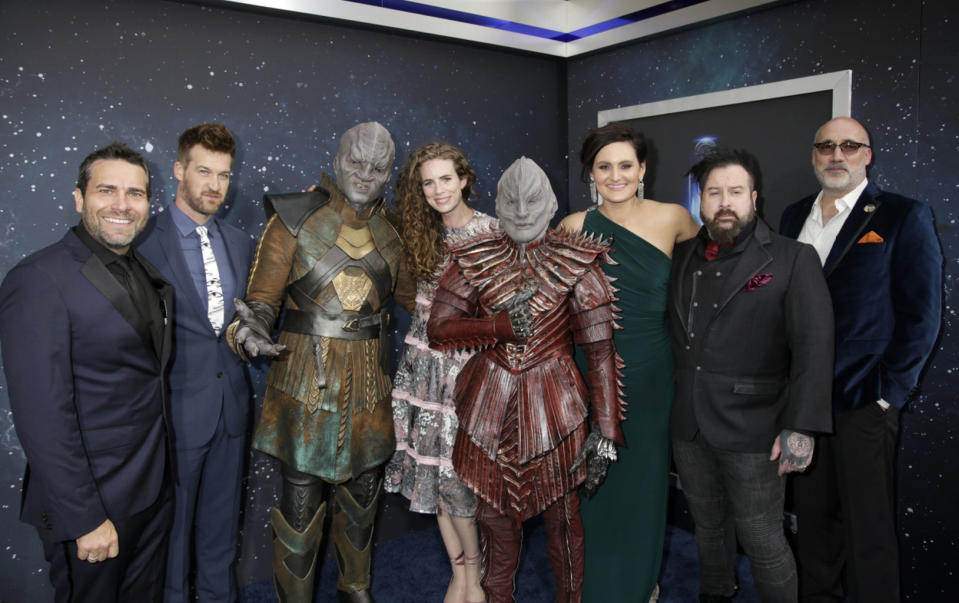 (L to R) James Mackinnon, actor Kenneth Mitchell, a Klingon, actress Clare McConnell, another Klingon, actress Mary Chieffo, creature and concept designer Neville Page and creature and make-up effects designer Glenn Hetrick, arrive on the Red Carpet for the "Star Trek: Discovery" premiere event. <cite>Francis Specker/CBS</cite>