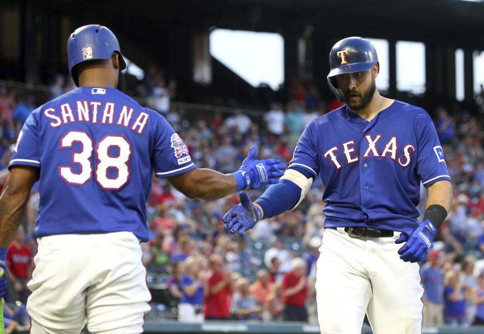 Texas Rangers' Danny Santana (38) celebrates the solo home run by Joey Gallo (13) during the fourth inning of the team's baseball game against the Arizona Diamondbacks Tuesday, July 16, 2019, in Arlington, Texas. (AP Photo/Richard W. Rodriguez)