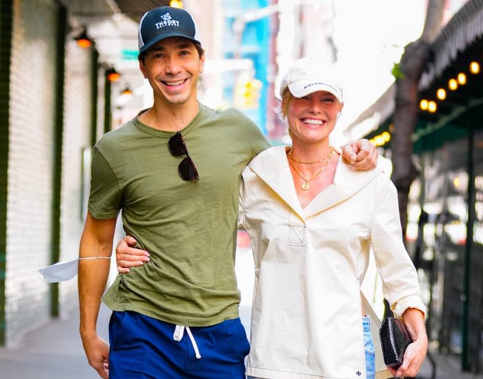 Justin and Kate smile while walking down the street