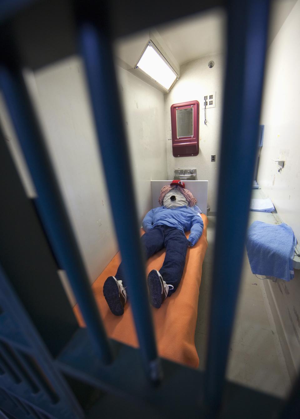 A dummy is placed inside a standard inmate cell for public tours at the Kingston Penitentiary in Kingston, Ontario October 11, 2013. British North America's first penitentiary, the "Kingston Pen" as it is known, is now closed. Situated on prime real estate on the shore of Lake Ontario, its fate is unknown despite being designated as a National Historic Site. Public tours are currently being held to raise money for the United Way. The prison was once home to Canada's most famous criminals including Canadian serial killers Clifford Olson and Paul Bernardo. REUTERS/Fred Thornhill (CANADA - Tags: CRIME LAW SOCIETY)