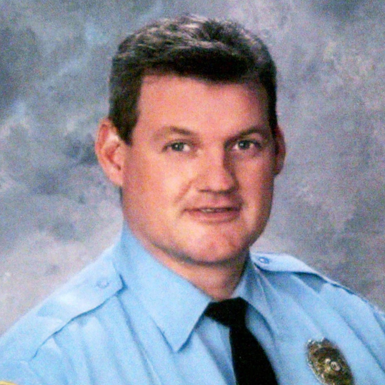 In this photo released Tuesday, July 5, 2005, by the Kirkwood Police Department Sgt. William McEntee, 43, is seen. McEntee was shot and killed while checking a fireworks disturbance in suburban St. Louis, and a search continued Wednesday for a man seen approaching the officer and firing several shots. Kirkwood Police Chief Jack Plummer said officers from several nearby departments and the Missouri State Highway Patrol joined Kirkwood police in searching for the suspect, who Plummer said frequented the neighborhood where the shooting took place. (AP Photo/Kirkwood Police Department via St. Louis Post-Dispatch) (Kirkwood Police Department/St. Louis Post-Dispatch via AP)