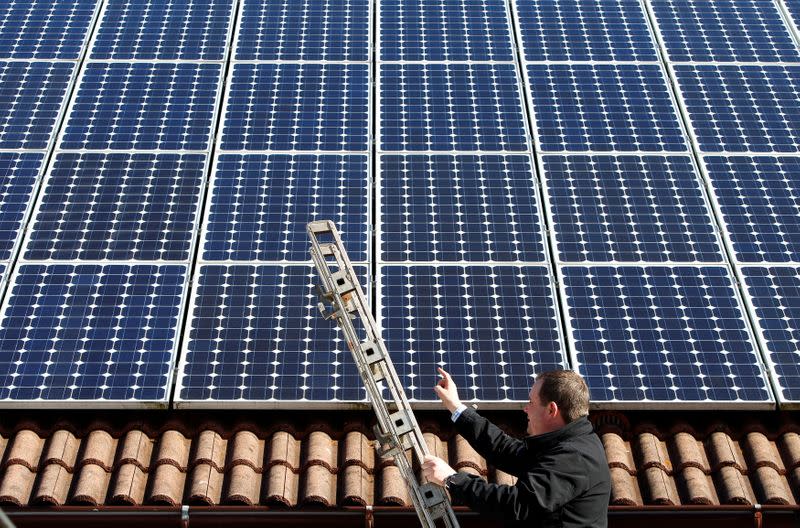 FILE PHOTO: Michael Greif controls his 56 photovoltaic (solar) panels at the roof of his house in Coburg