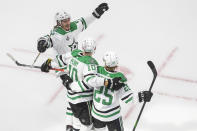 Dallas Stars' Joel Kiviranta (25) celebrates his goal with teammates right wing Corey Perry (10) and Dallas Stars left wing Roope Hintz (24) against the Tampa Bay Lightning during second-period NHL Stanley Cup finals hockey action in Edmonton, Alberta, Saturday, Sept. 19, 2020. (Jason Franson/The Canadian Press via AP)