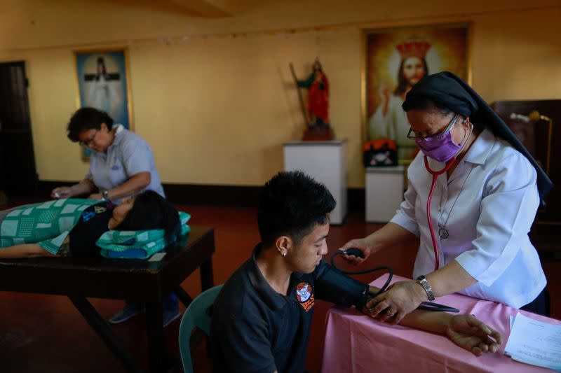 Drug rehab patients get checked up at a community drug rehabilitation facility in Caloocan, Metro Manila