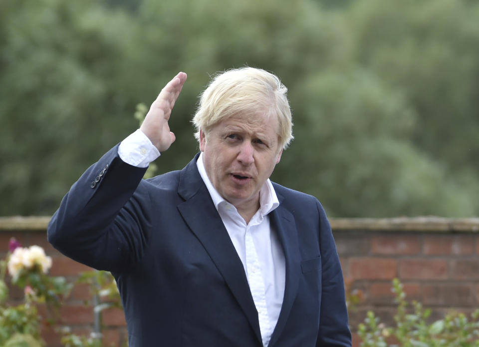 Britain's Prime Minister Boris Johnson speaks to local people at the Canal Side Heritage Centre in Beeston near Nottingham, England, Tuesday, July 28, 2020. The government is launching a new cycling intuitive to help get people fitter. (AP Photo/Rui Vieira, Pool)