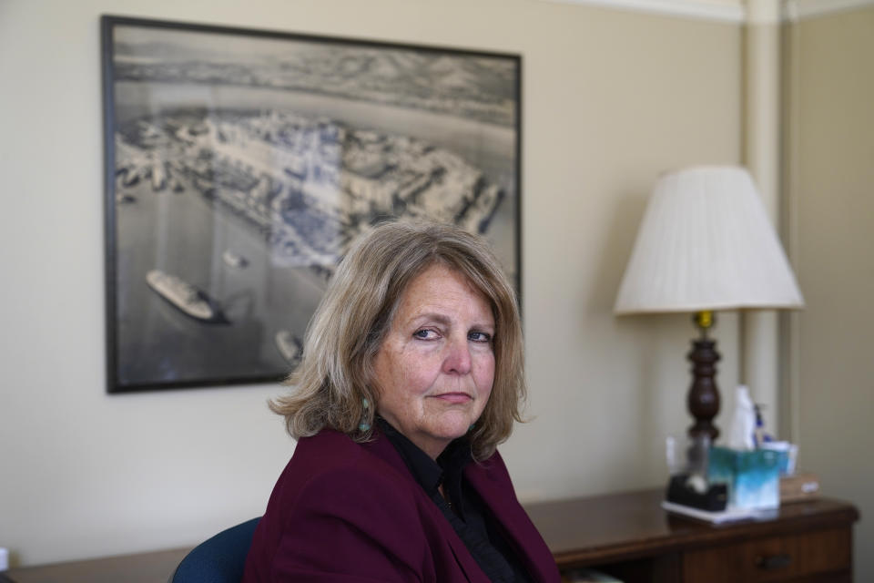 Sherry Williams, executive director of One Treasure Island, poses for a photo at her office on Tuesday, April 5, 2022, in San Francisco. Business Email Compromise scams are a type of crime where criminals hack into email accounts, pretend to be someone they're not and fool victims into sending money to places they aren't supposed to. In the case of Williams, the San Francisco nonprofit director, thieves hacked the email account of the nonprofit's bookkeeper then inserted themselves into a long email thread, sent messages asking to change the wire payment instructions for a grant recipient, and made off with $650,000. (AP Photo/Eric Risberg)