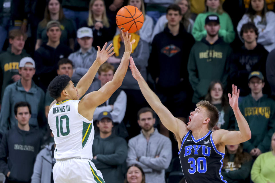 Baylor guard RayJ Dennis (10) shoots as BYU guard Dallin Hall (30) defends during the first half of an NCAA college basketball game Tuesday, Jan. 9, 2024, in Waco, Texas. (AP Photo/Gareth Patterson)