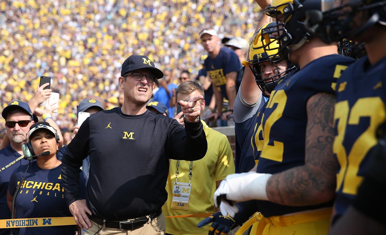 ANN ARBOR, MI – SEPTEMBER 16: Michigan Wolverines head football coach Jim Harbaugh leads his team onto the field prior to the start of the game against the Air Force Falcons at Michigan Stadium on September 16, 2017 in Ann Arbor, Michigan.(Photo by Leon Halip/Getty Images)